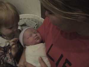 Amy holds baby Esther as Sarah delights in her new little sister