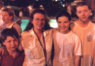 Terri congratulates Micah, Amy, and Andrew after their baptism
